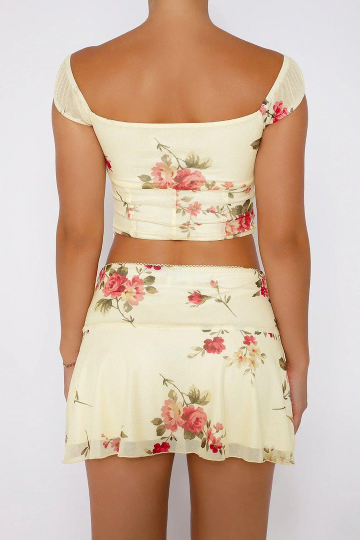 Malia women's floral print summer set with a stylish bow top and a high-waisted mini skirt, ideal for holidays.