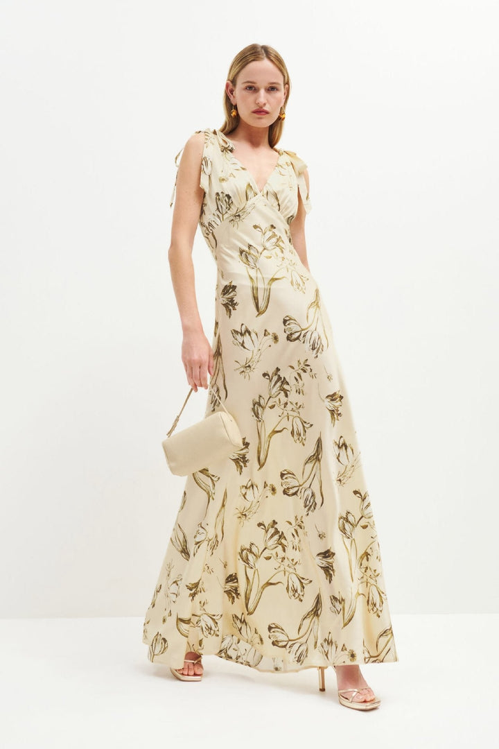 Women's flowing beige floral maxi dress with elegant button details, perfect for summer holidays & casual wear.