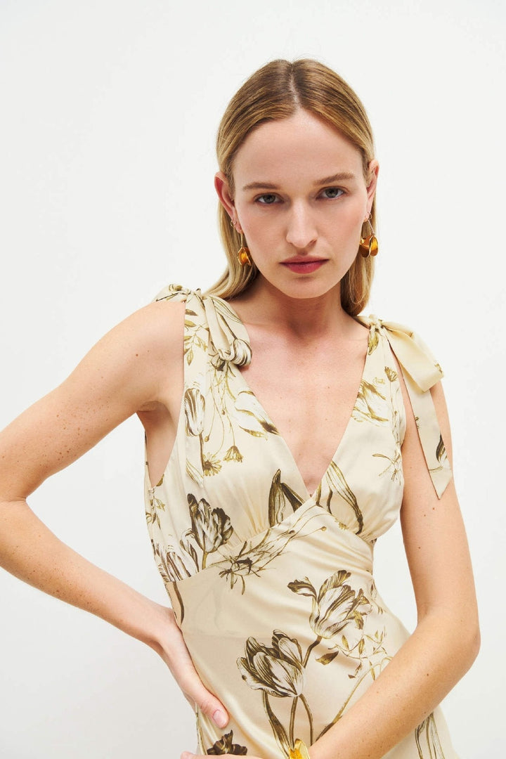 Elegant A-line beige floral maxi dress for women, sleeveless with charming button accents, ideal for vacation.