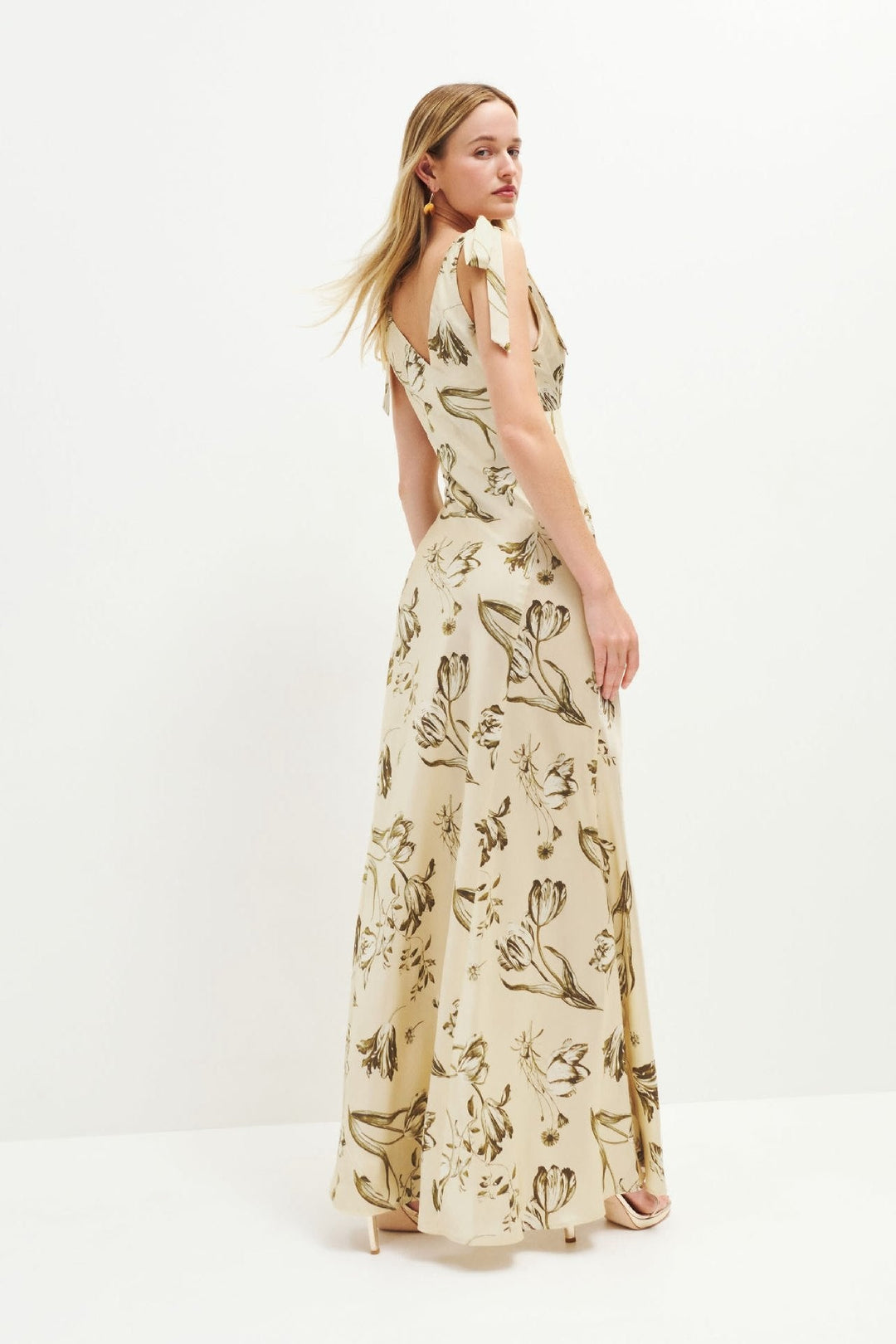Lightweight beige floral maxi dress for women, featuring flowing fabric & front button details. Great summer style.
