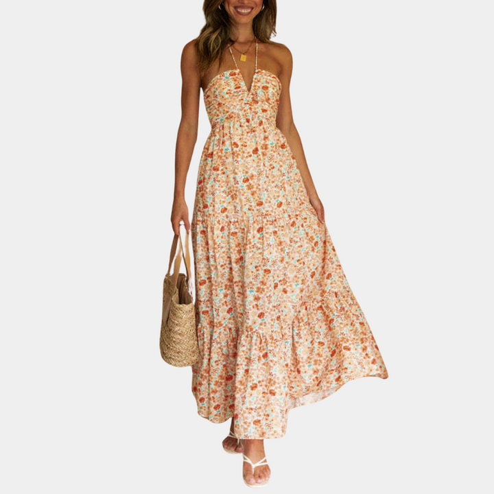 Women's flowy boho halter neck maxi dress in a vibrant summer color, perfect for vacation.
