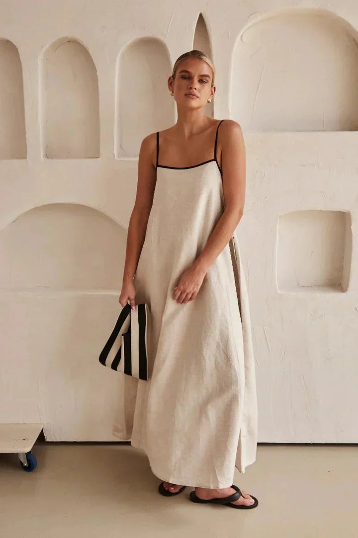Women's flowy sleeveless beige boho maxi dress, perfect for casual summer days.