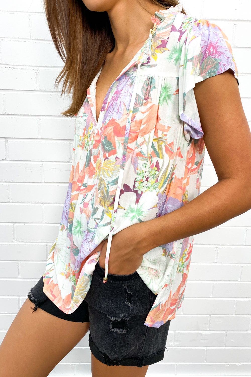 Women's flowy V-neck summer top with stylish fringe detail, perfect for warm weather casual wear.