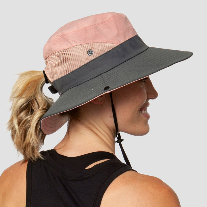 Foldable beach sun hat for women with UV protection & ponytail opening. Perfect for seaside relaxation.