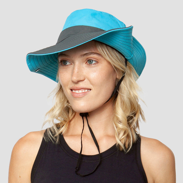 Compact foldable women's travel sun hat. UV protection, wide brim, & ponytail opening for easy packing.