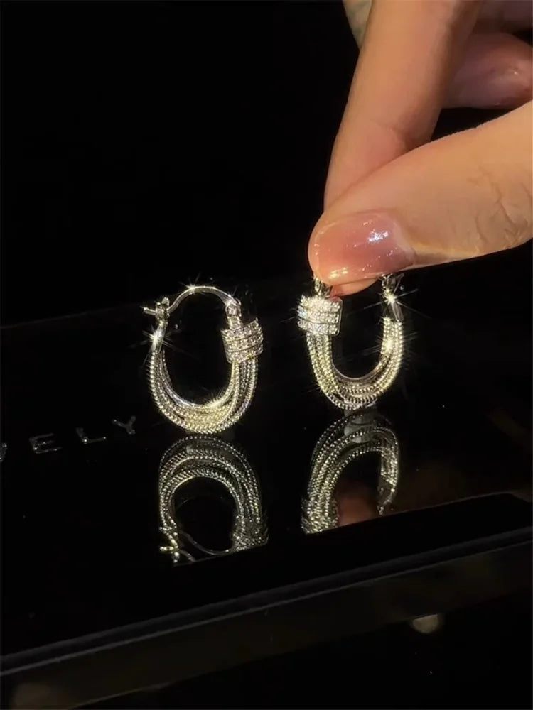 Modern geometric layered stud earrings for women. Fashionable and elegant accessory, perfect for any occasion.