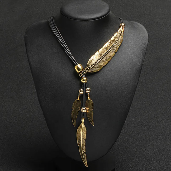 Bohemian gold feather pendant necklace for women. Chic and elegant, this unique jewelry adds a stylish touch.