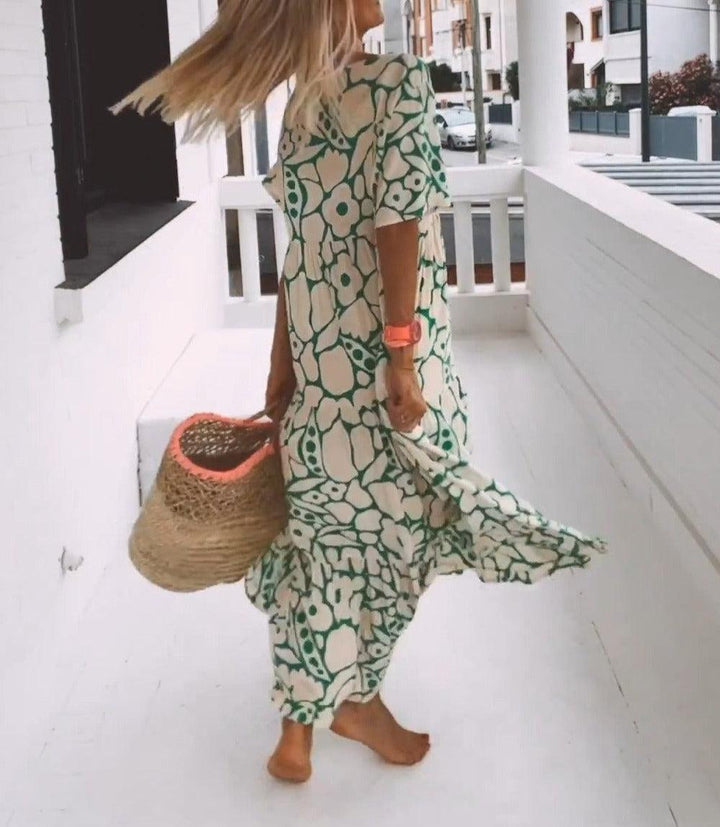 Flowy green floral print maxi dress for women with short sleeves. A stylish and breathable summer dress.