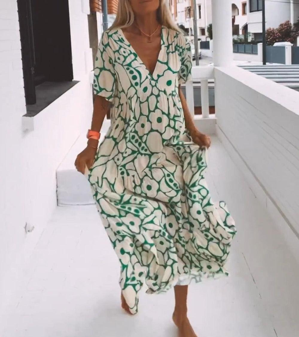 Women's vibrant green floral pattern maxi dress, short sleeves. Chic V-neck design, perfect for warm weather.
