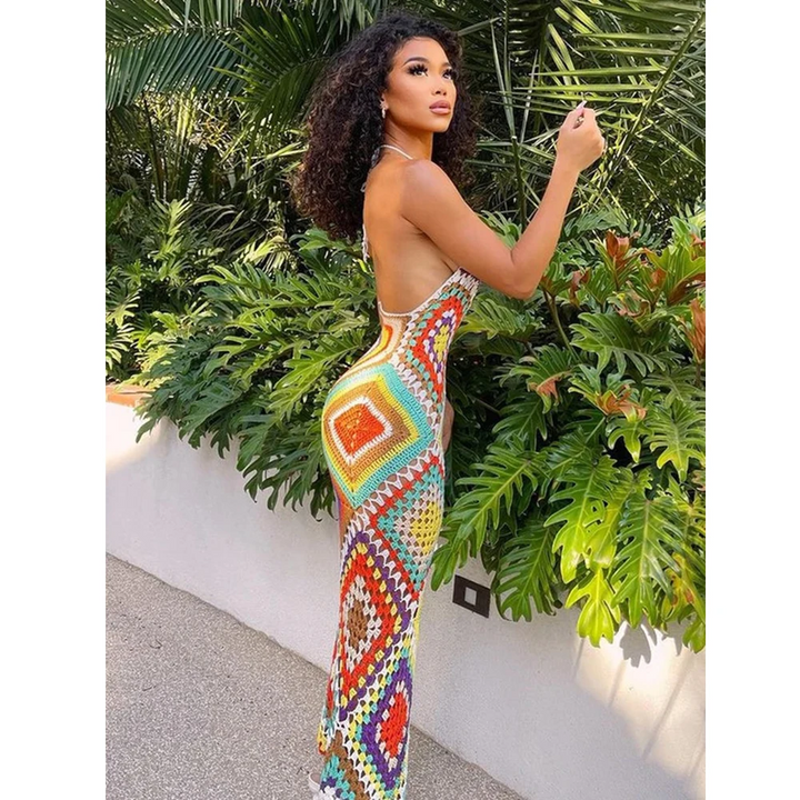 Sleeveless long crocheted beach cover-up for women. Handmade boho design, perfect for summer resort wear.