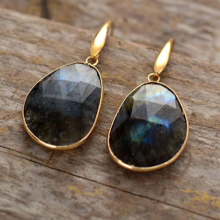 Close-up of women's labradorite dreamy crystal earrings, showcasing iridescent gemstone and handcrafted detail.