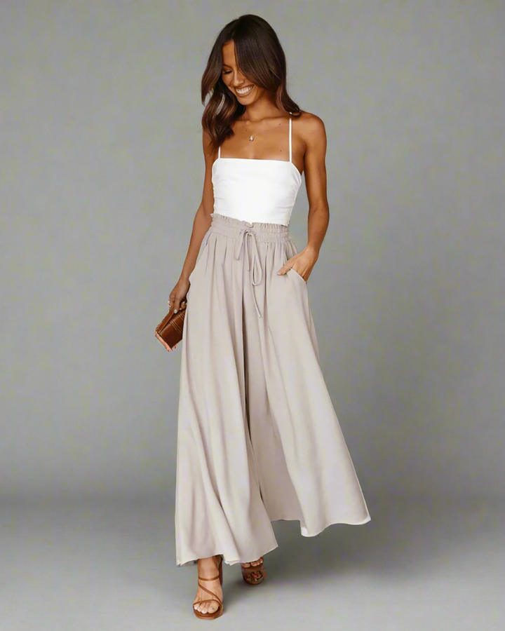 Model wearing women's high-waisted summer trousers, demonstrating their flattering fit and relaxed look.