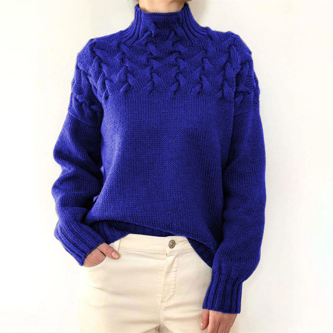Detailed view of women's knitted turtleneck sweater, showcasing soft texture & elegant design.
