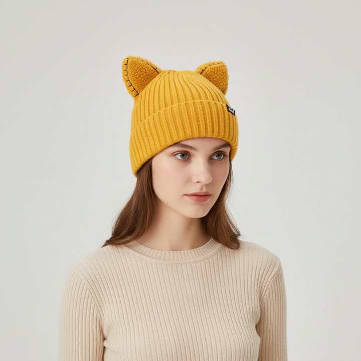 Detail of the knit pattern on a women's cat ear winter hat, black yarn