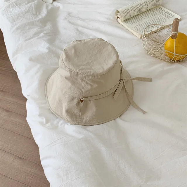 Women's lace-up fisherman hat with wide brim for stylish sun protection.