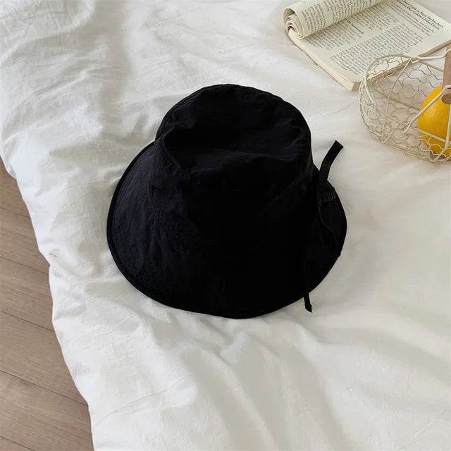 Versatile women's fisherman hat, adjustable lace-up, ideal for travel & outdoor sun.