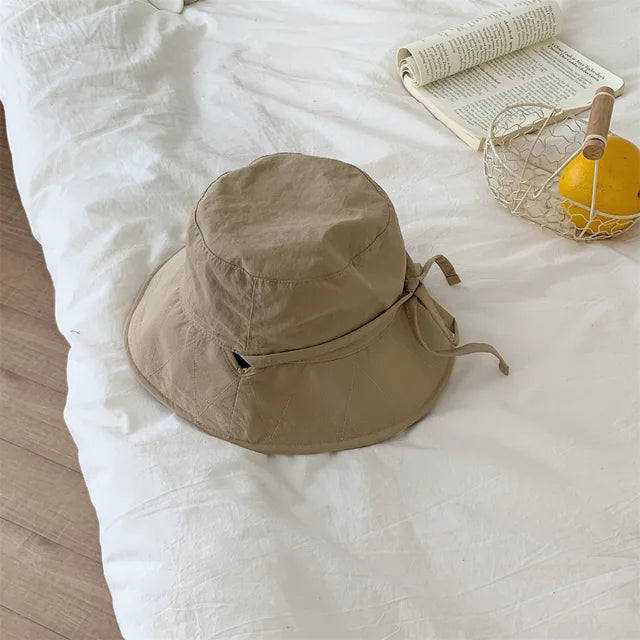 Fashionable women's lace-up hat, fisherman style, offering excellent sun protection.