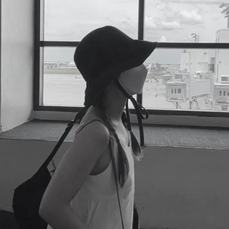 Elegant women's sun hat, lace-up detail, wide brim for ultimate protection & style.