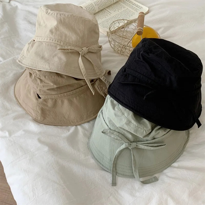 Outdoor chic women's bucket hat, lace-up for a secure fit & effective sun protection.