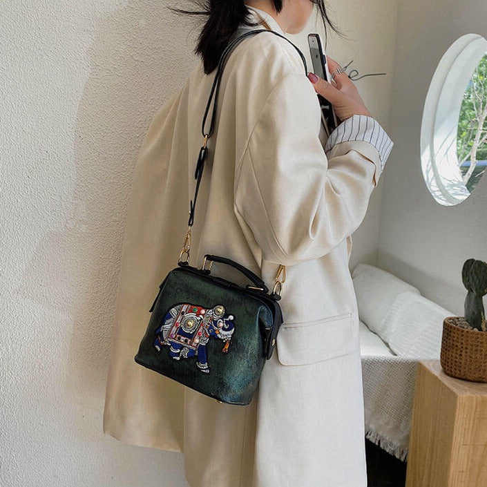 Artistic PU coated cotton women's bohemian crossbody bag with intricate mandala embroidery.