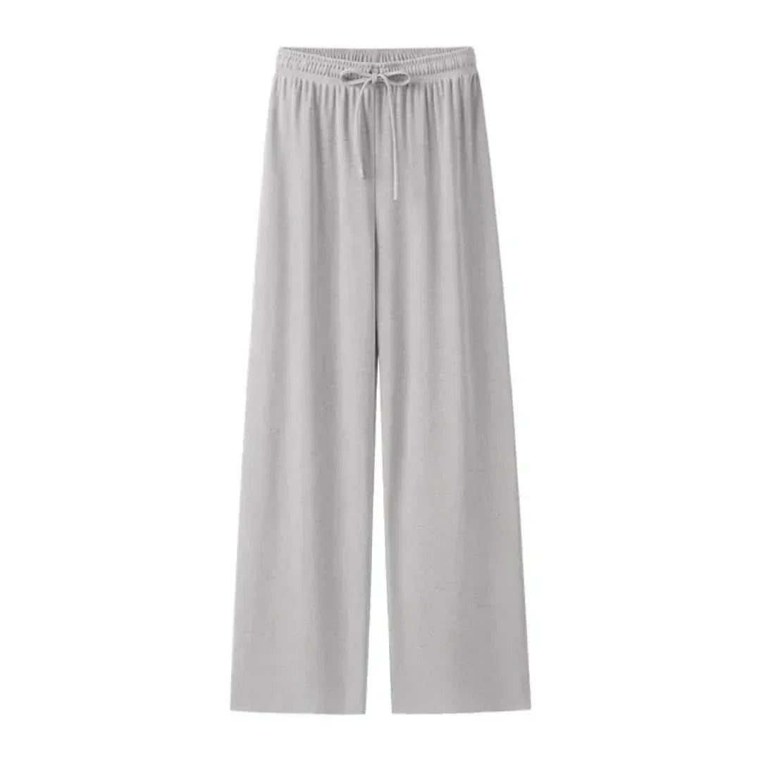 Model wearing Mira lightweight linen blend trousers, side view, relaxed fit