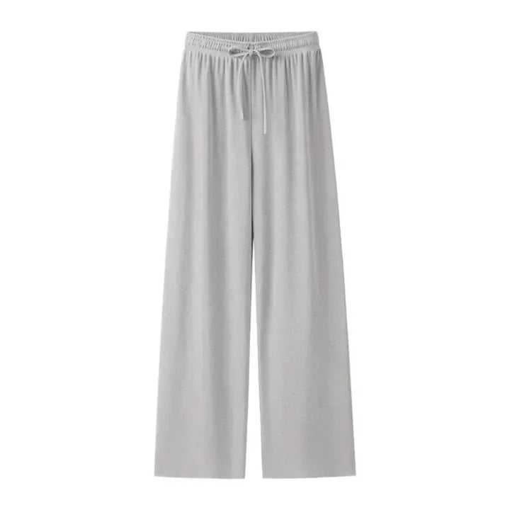 Model wearing Mira lightweight linen blend trousers, side view, relaxed fit