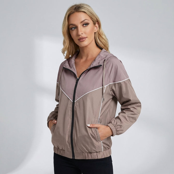 Women's activewear windbreaker, water-repellent, with adjustable hood and color block.
