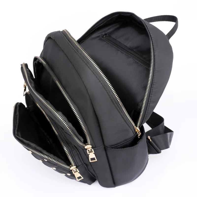Open women's lightweight nylon backpack revealing spacious interior & organizational pockets. Great for school & travel.