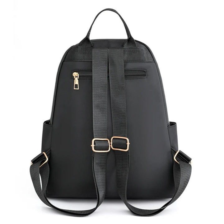 Close-up of durable water-resistant nylon fabric on women's lightweight backpack. High-quality material for daily & travel use.