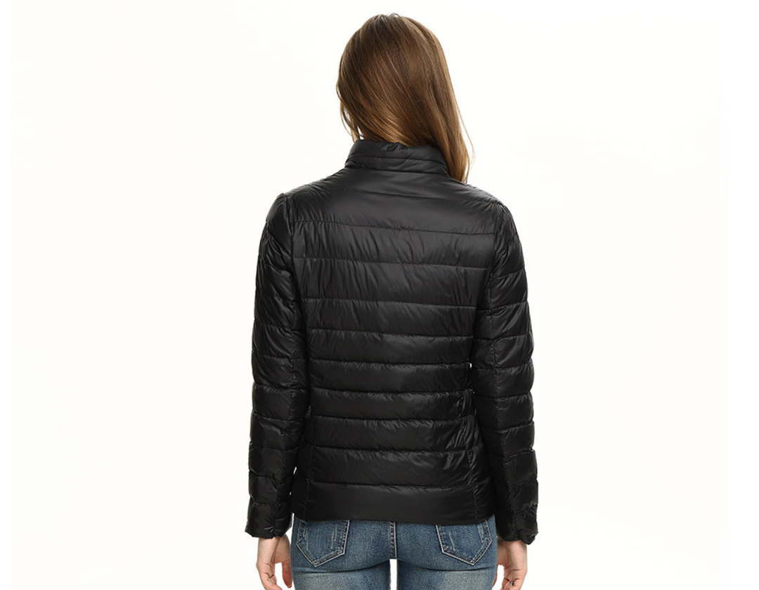 Packable women's waterproof jacket, essential outerwear for travel & casual urban exploring.