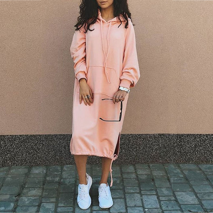 Stylish women's long oversized hoodie worn by a model, perfect for a chic street style look.