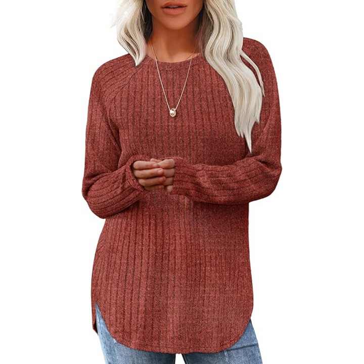 Model wearing a women's loose fit crew neck long sleeve sweater tunic with jeans