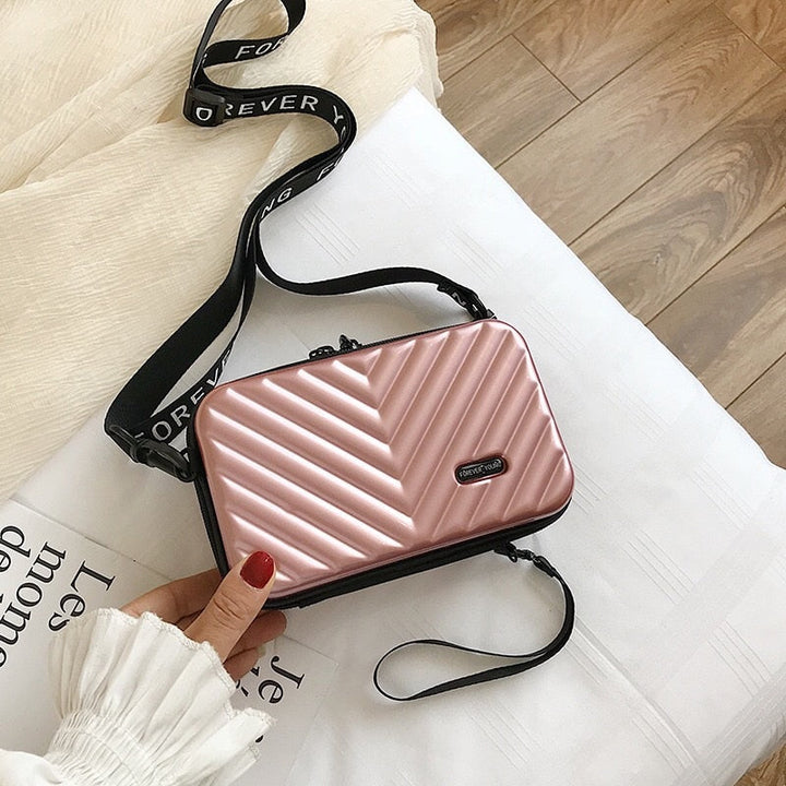 Stylish women's mini hard shell shoulder bag in black, perfect for travel