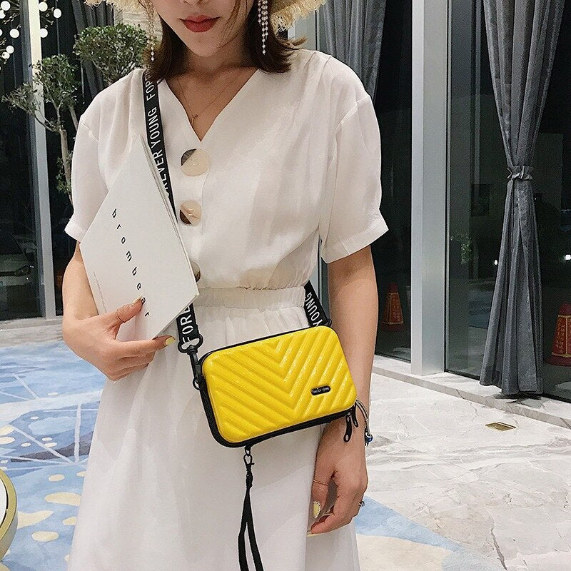 Black mini hard shell shoulder bag with adjustable strap, women's travel essential