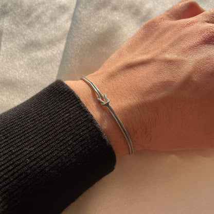 Women's minimalist gold knot bracelet for elegant everyday style.