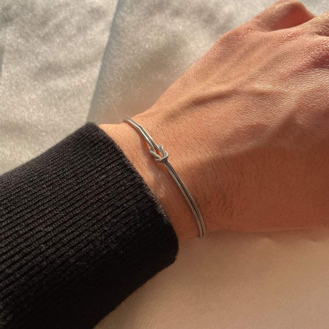 Feminine gold minimalist knot bracelet, ideal for understated style.