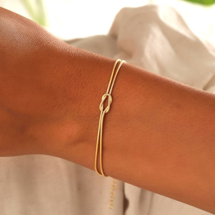 Everyday essential: women's gold minimalist knot bracelet, easy to style.