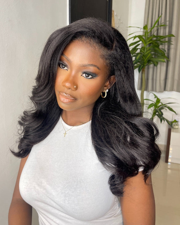 Natural black HD lace front wig featuring a body wave texture & stylish curly edges. Virgin human hair for women.