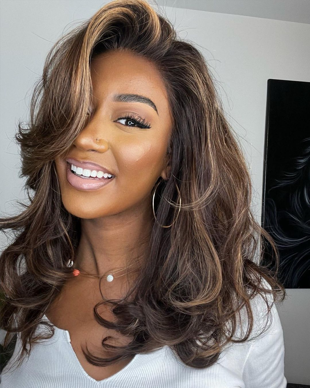Women's natural human hair lace front wig with wavy blonde highlights on brown hair for a seamless look.
