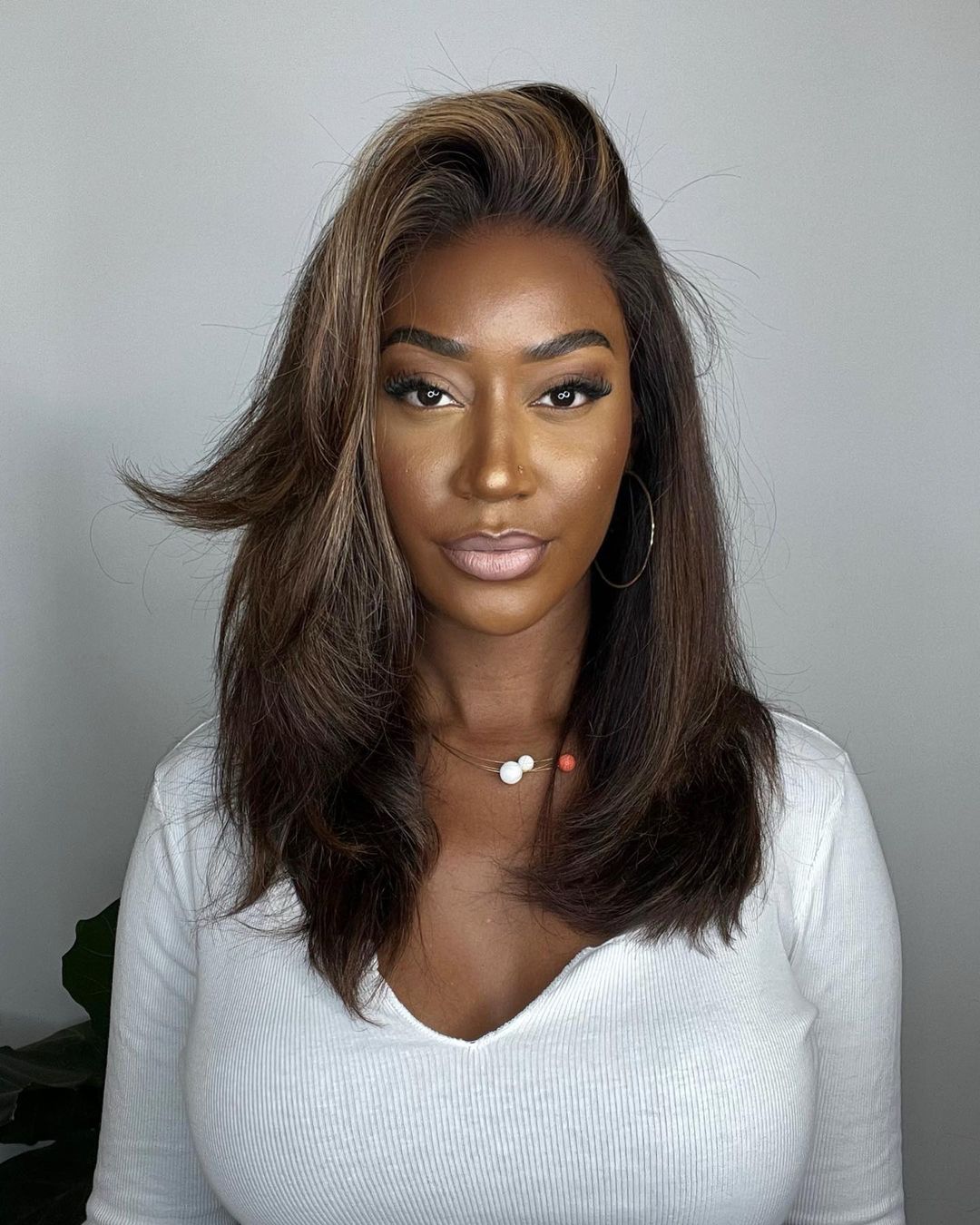 Flawless natural human hair lace front wig. Wavy brown hair with bright blonde highlights for a vibrant look.