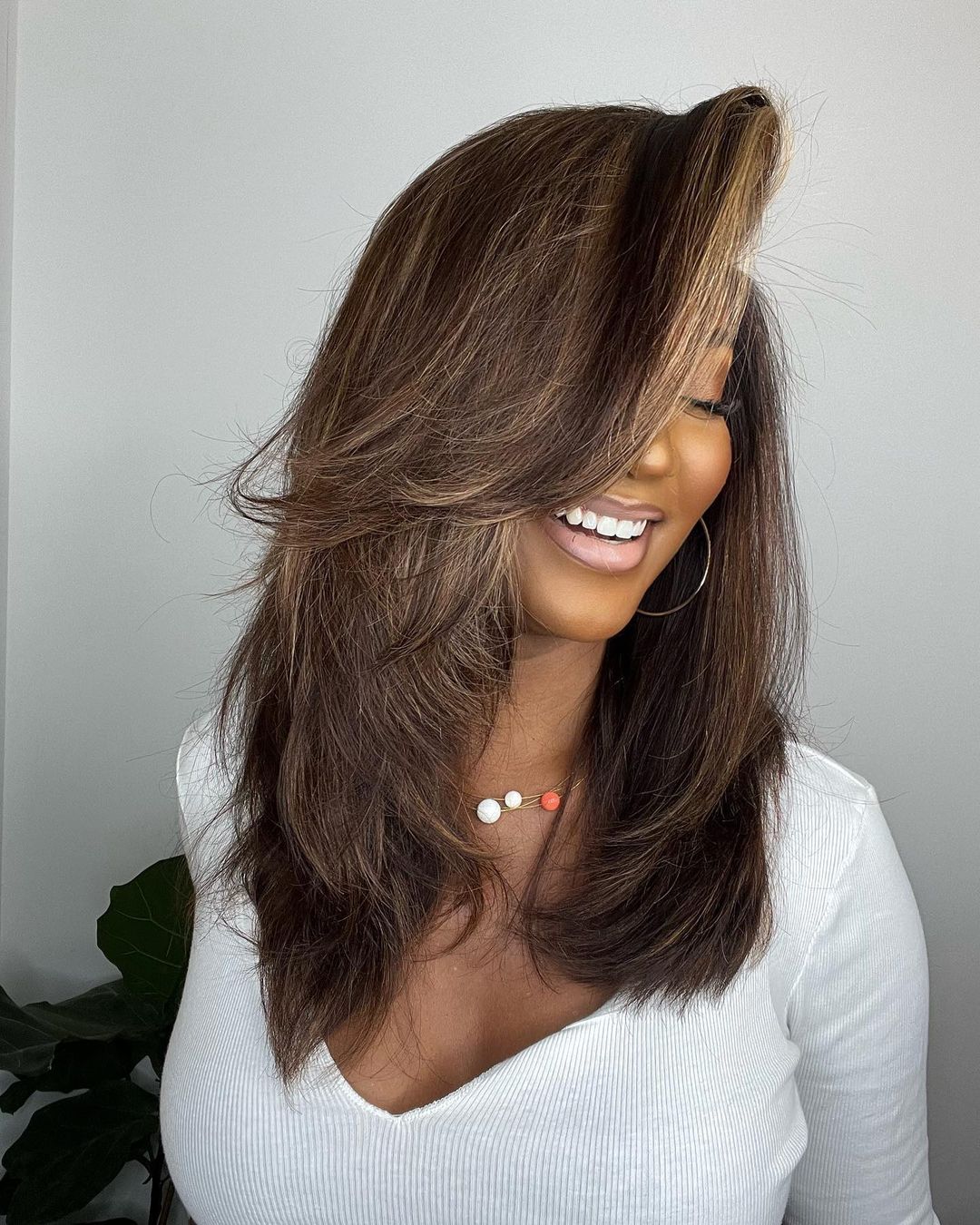 Brown human hair lace front wig featuring trendy blonde highlights. Wavy texture provides a natural, full appearance.
