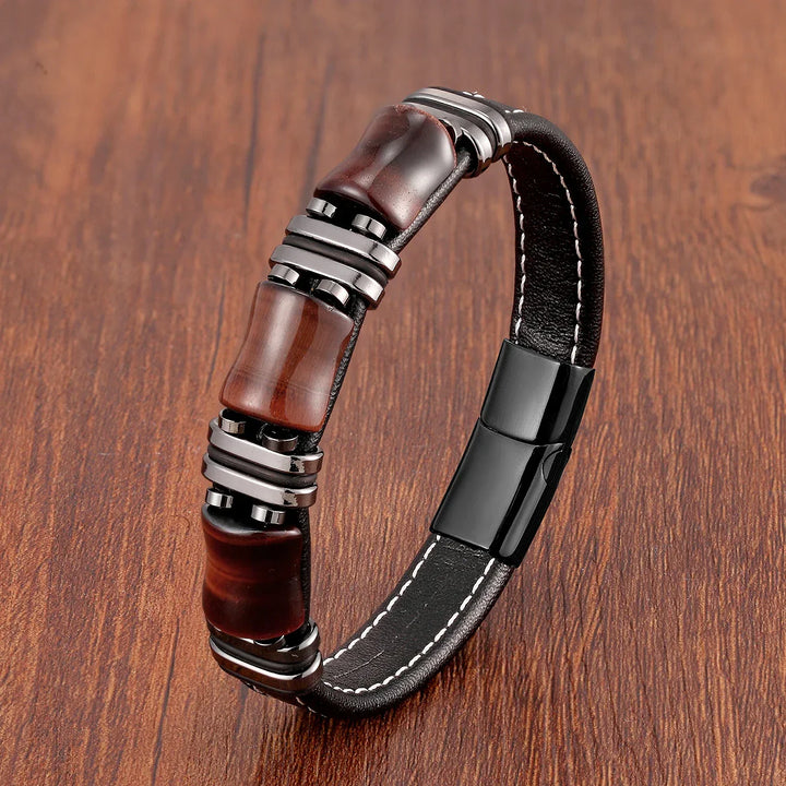 Close-up of women's tiger eye and leather bracelet, showcasing gemstone detail