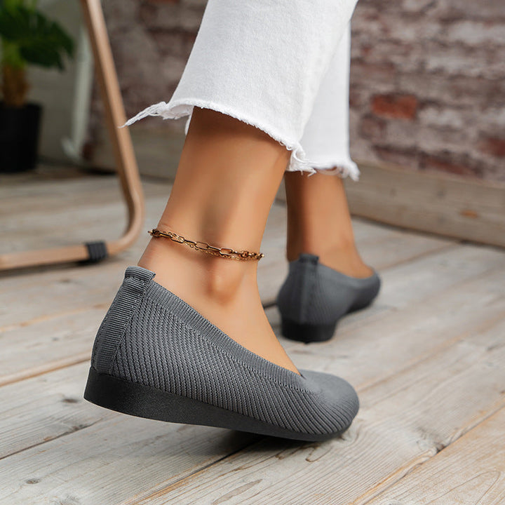 Woman wearing stylish orthopedic ballerinas, perfect for office or casual comfort.
