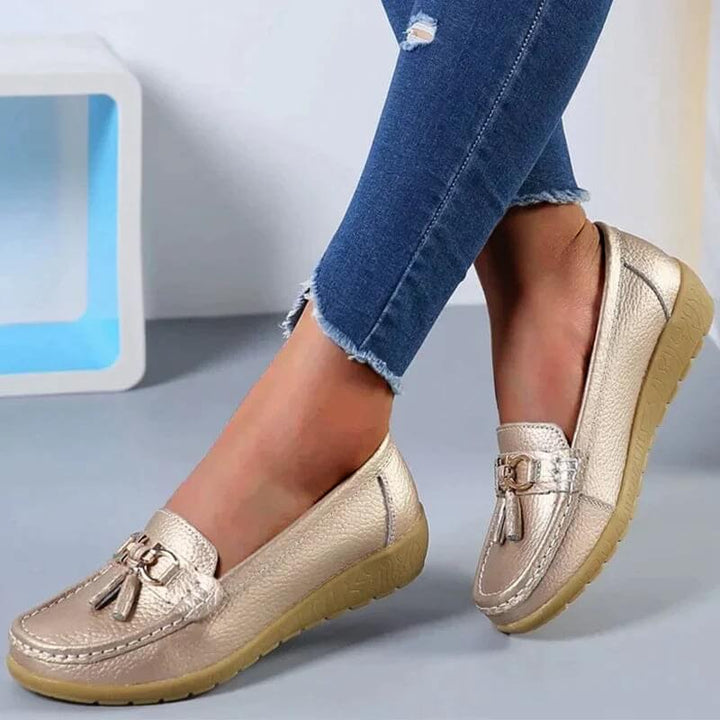 Close-up of women's orthopedic slip-on loafers, highlighting soft material & comfortable design for foot support.