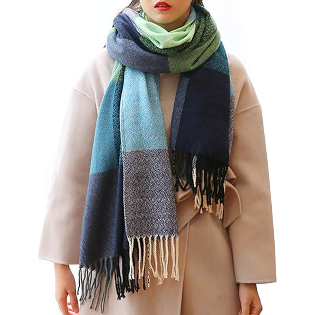 A woman's face peeking from an oversized plaid winter scarf, emphasizing its cozy warmth.