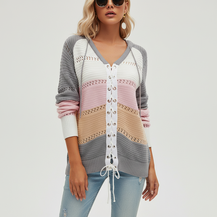 Fashionable women's knit pullover, long sleeve, showcasing striped patchwork and lace-up accents