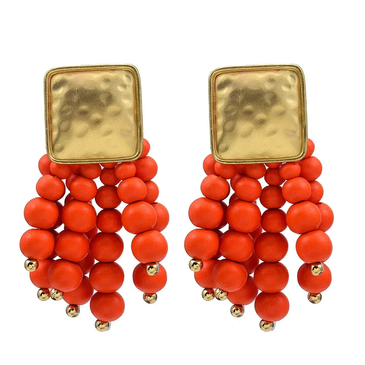 Handmade wooden pearl-shaped drop earrings. Natural, unique women's fashion accessory. Statement jewelry.