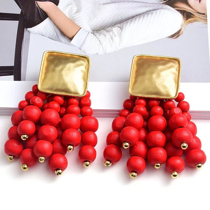 Stylish wooden pearl-shaped chain drop earrings. Unique handmade natural jewelry for women's modern boho look.