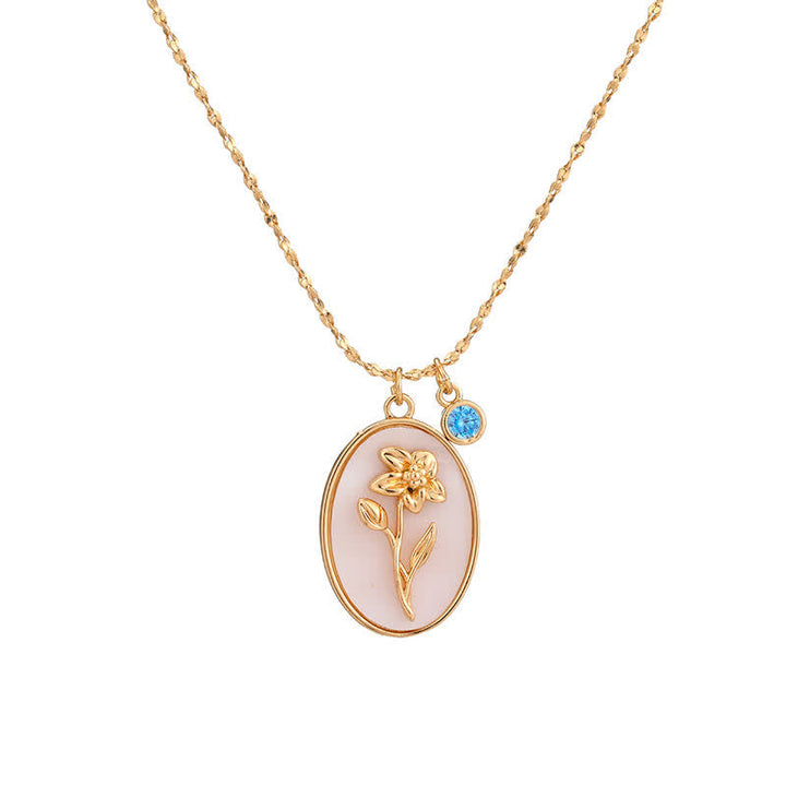 Personalized women's silver birthstone necklace featuring a detailed birth flower design.