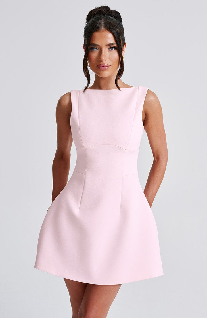 Stylish women's pink sleeveless halter mini dress with an open back, perfect for summer fashion & casual events.